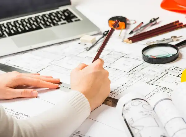 Custom home interior design planning with blueprints and drafting tools